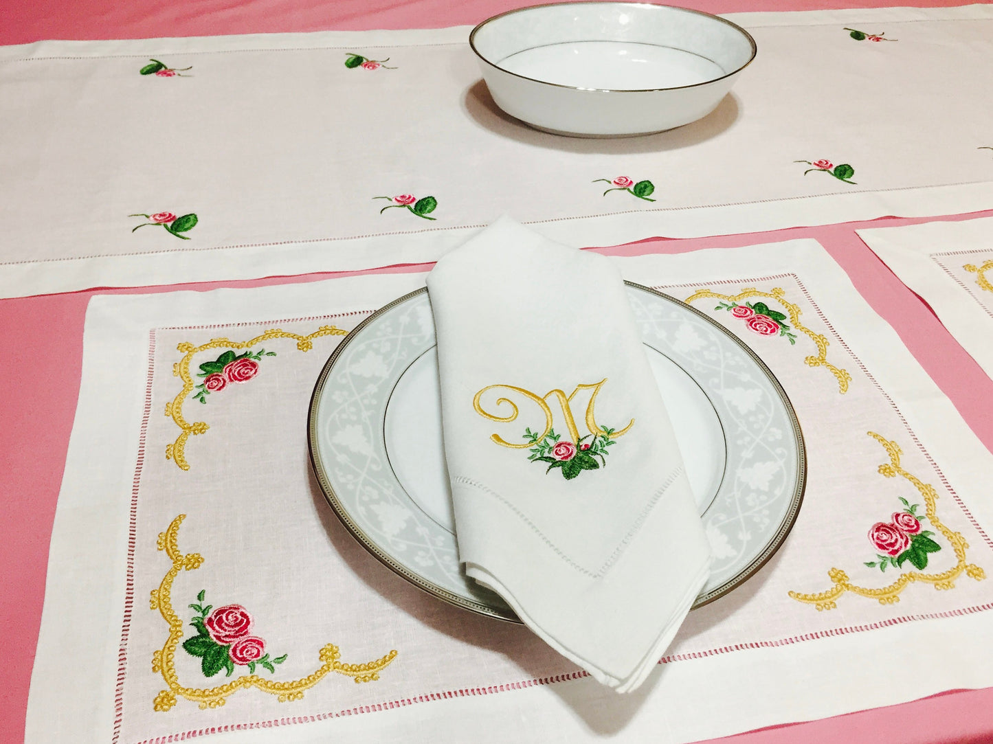 collection of table linens embroidered with roses