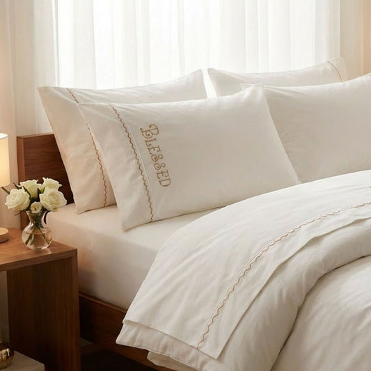 Blessed embroidered bed sheets in 600 thread count 100% cotton. White luxury bedding with scallop trim and custom color embroidery.