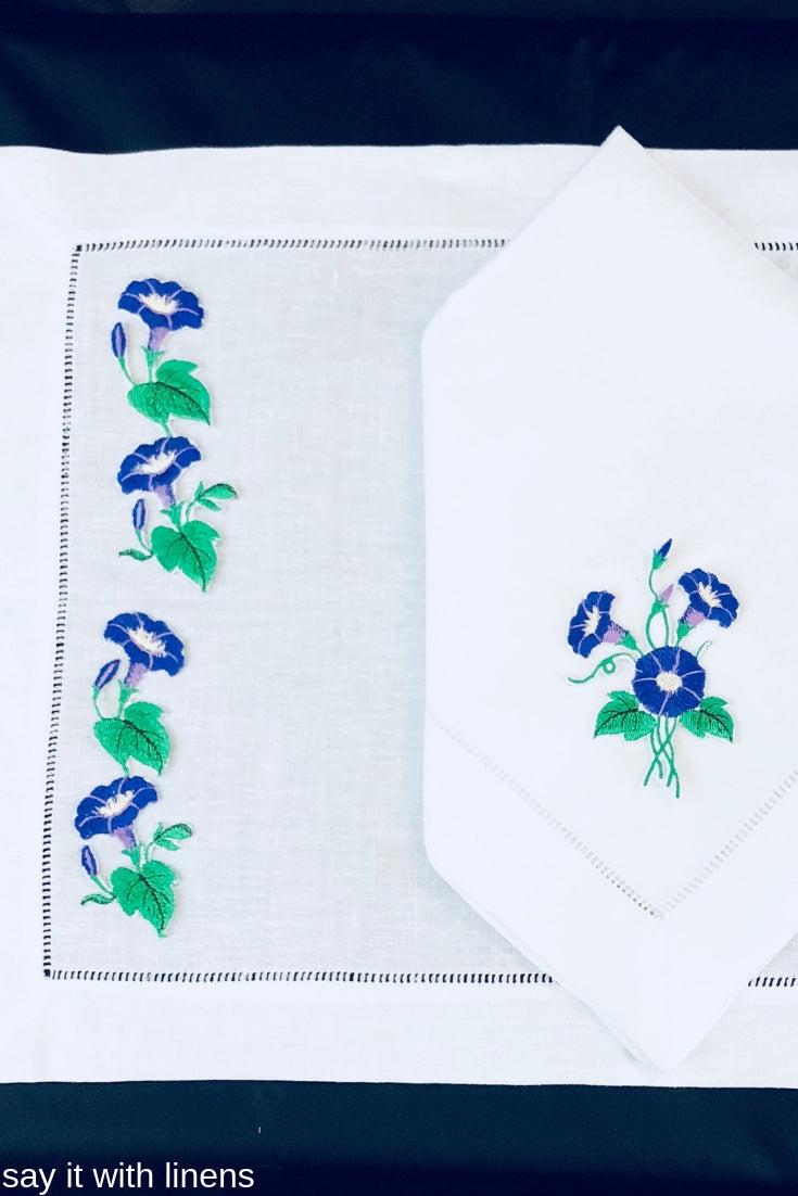 matching placemat and dinner napkin embroidered with morning glory flower desing