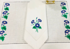 linen placemat and linen dinner napkins embroidered with purple morning glory flowers 